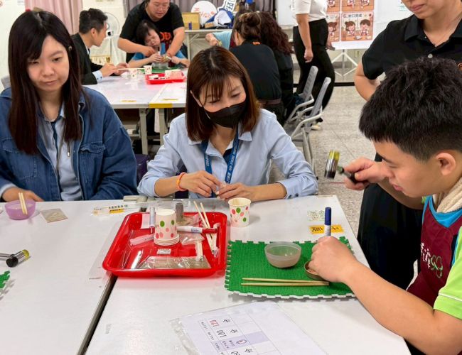 身障学员认真示范如何让艾草绒压实成条。